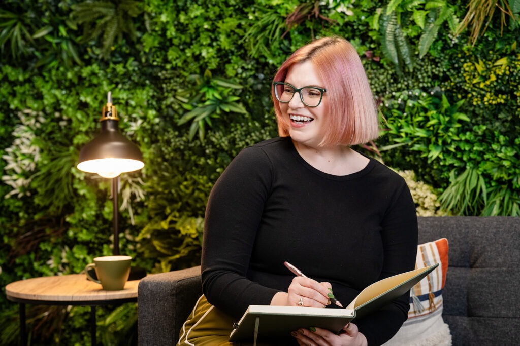 Charlotte writing in a notpad